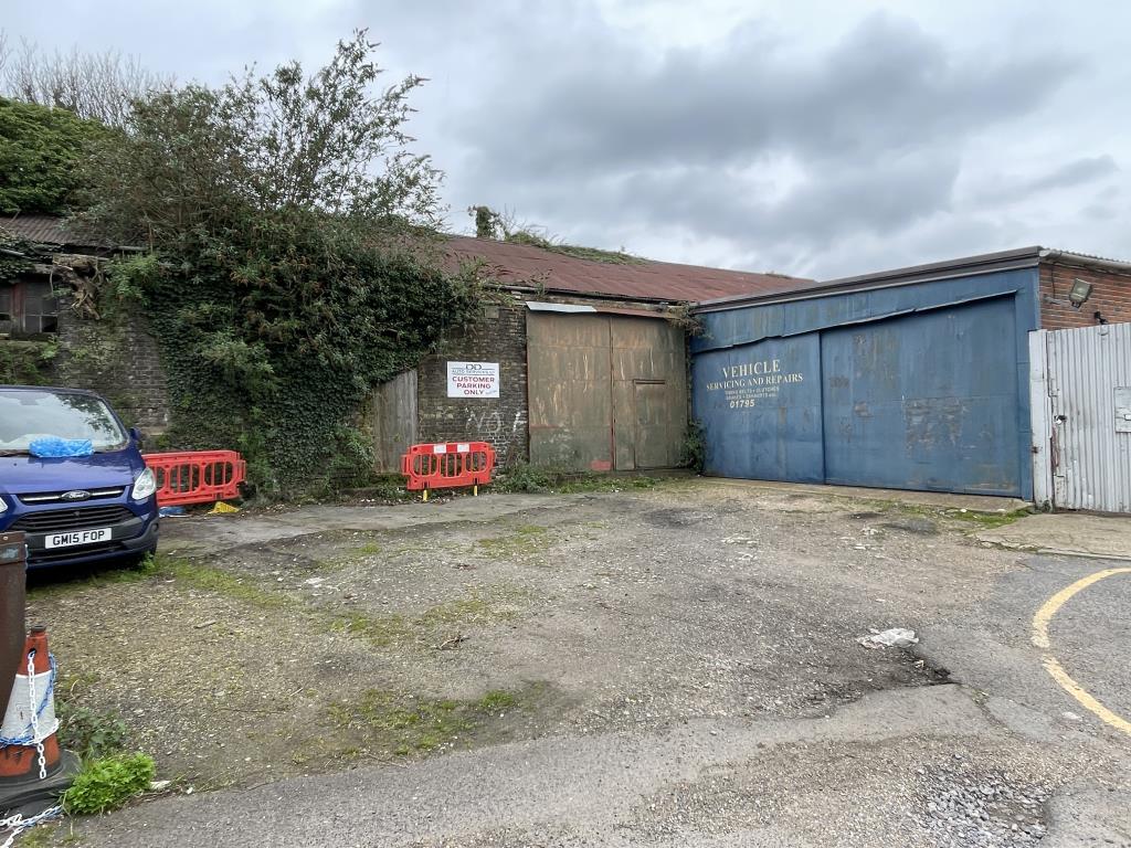 Lot: 48 - VALUABLE WORKSHOPS WITH OFFICES AND YARD AREA CLOSE TO TOWN CENTRE - View of rear of workshops and parking area